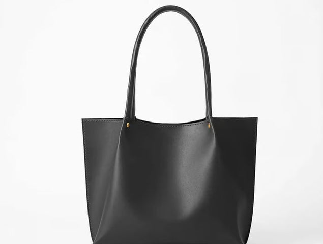 Classic black leather tote bag with dual handles for everyday carry
