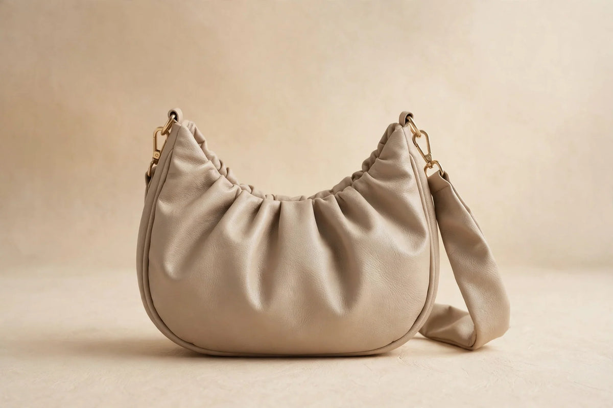 The Hobo beige slouchy shoulder bag in faux leather, product hero photograph