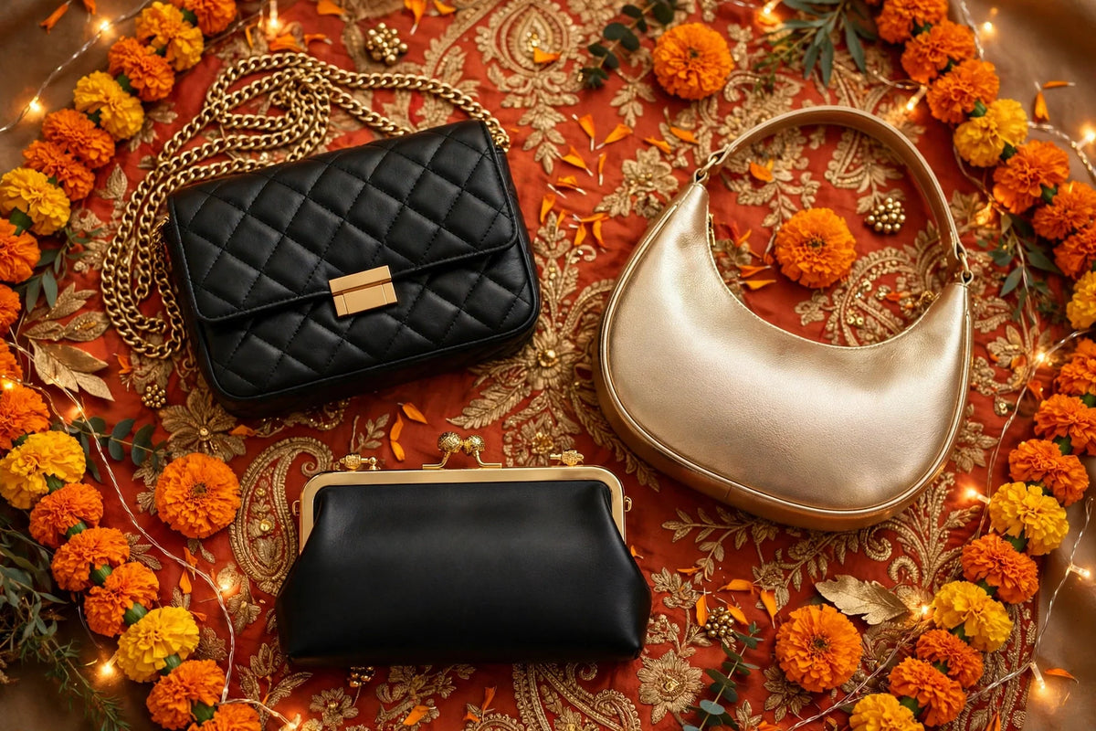 Wedding guest handbag flat-lay: quilted black chain crossbody, black hand clutch and champagne crescent bag on festive marigold and embroidered fabric